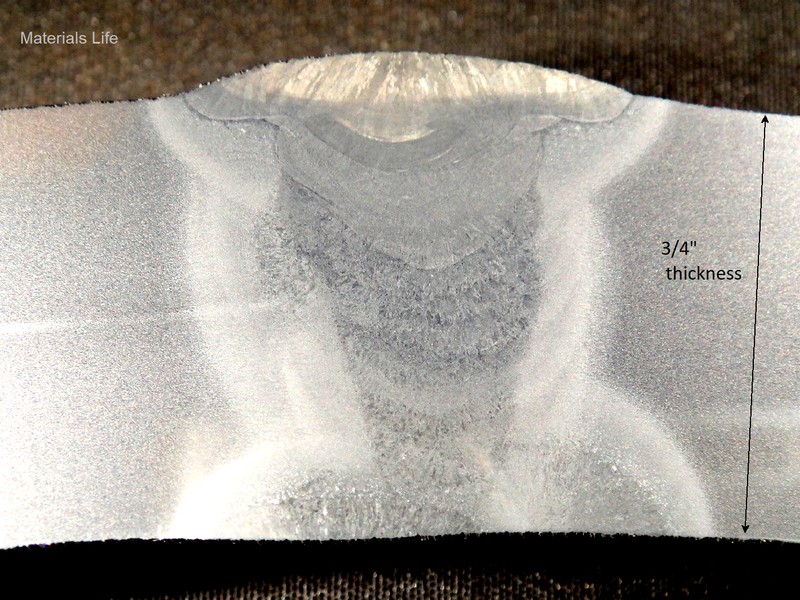 Macrography of the longitudinally seam weld of the 24" diameter tube, showing that it was welded from both sides and there is a segregation line in the center of the tube thickness.