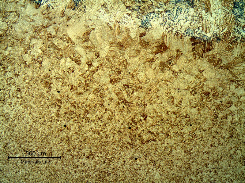 Fusion line of the forging side, in the cap, showing the weld metal (to the top of the image) and the base metal (to the bottom of the image). The heat affected zone hardness is about 270HV10.
