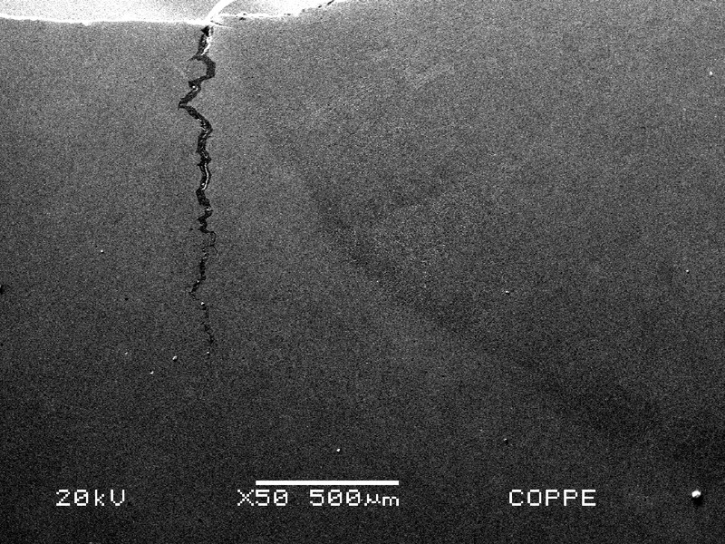 The cracking is located at the margin of the weld in the forging side. It is 1.2 mm deep.
