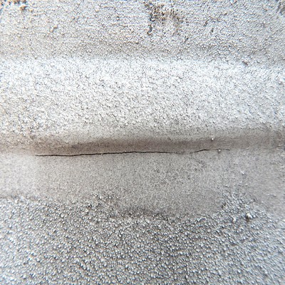 The dye check image shows the detected crack, 50 mm long, at the margin of the weld in the forging side.