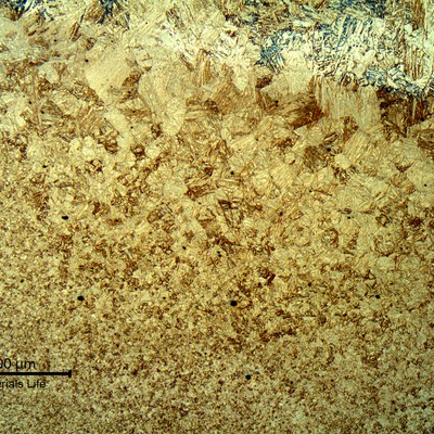 Fusion line of the forging side, in the cap, showing the weld metal (to the top of the image) and the base metal (to the bottom of the image). The heat affected zone hardness is about 270HV10.