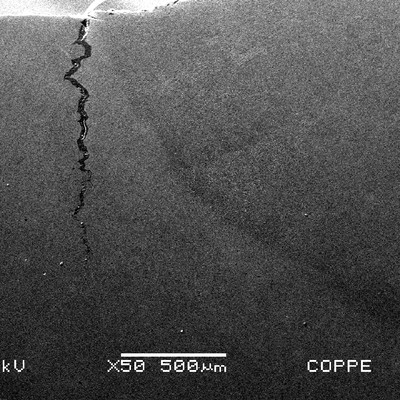 The cracking is located at the margin of the weld in the forging side. It is 1.2 mm deep.