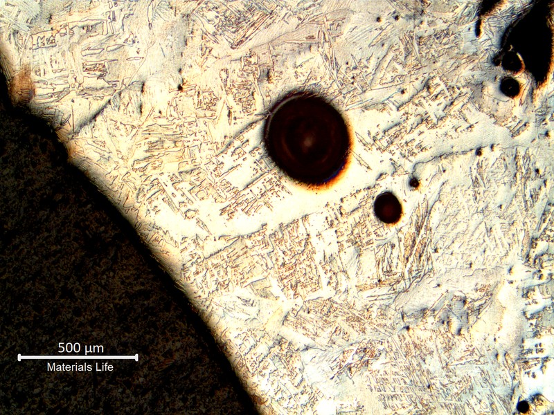 Low magnification micrography showing the weld metal, full of pores, indicating that the field welding was not properly shileded.