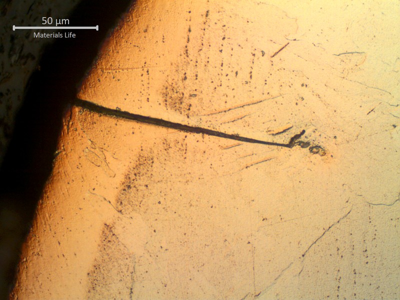 Micrographic detail of the brittle crack in the surface of the welded joint, at the heat affected zone close to the fusion line.