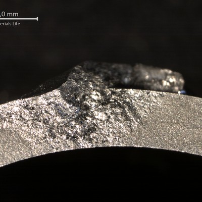 Aspect of the opened crack, showing the flat fracture.  The through wall cracking started at the welded  region at the end of the rib.