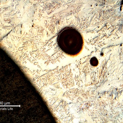 Low magnification micrography showing the weld metal, full of pores, indicating that the field welding was not properly shileded.
