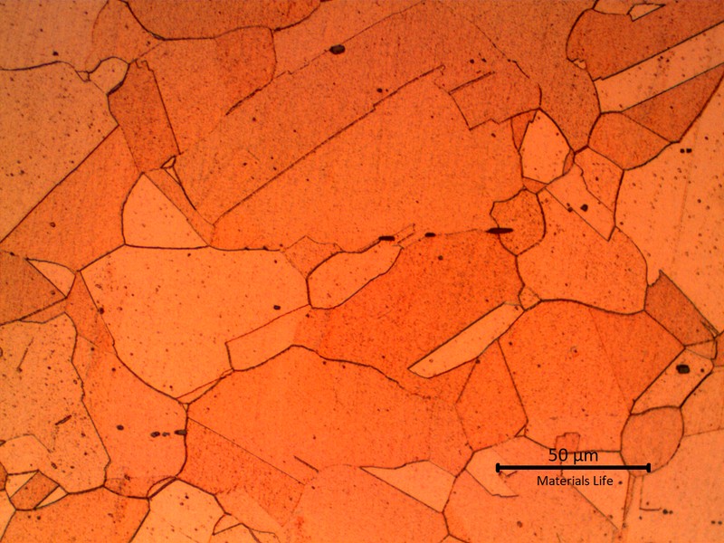 Micrographic detail of the granular copper structure, out of the damaged area. The dark particles are non metallic (oxides).