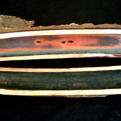 Macroscopic aspect after cutting longitudinally in two halfs, at the damaged area. The tube internal surface showed a red copper colour at the overheated region and the perforation is associated to longitudinal cracks.