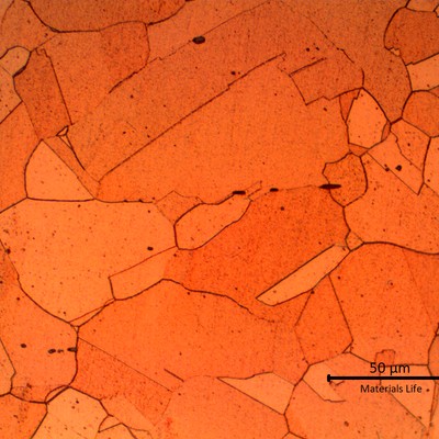Micrographic detail of the granular copper structure, out of the damaged area. The dark particles are non metallic (oxides).