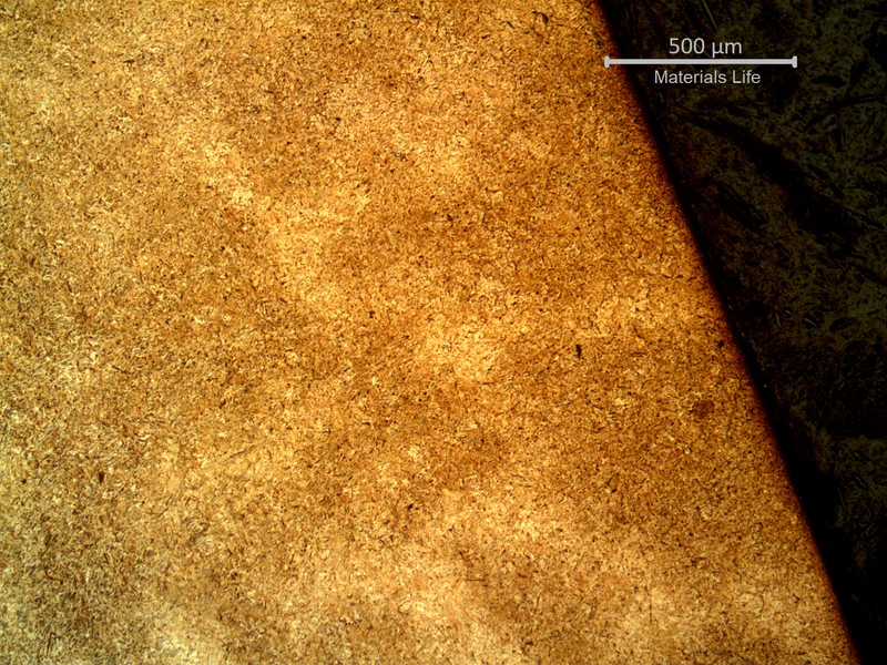 Micrography of the tooth gear, in a transverse section, close to surface.  The material presents light ghost marks that reveal chemical segregations.