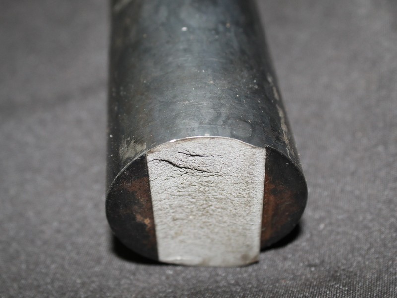 Flat fracture, no plastic deformation, at the notch in the recess.