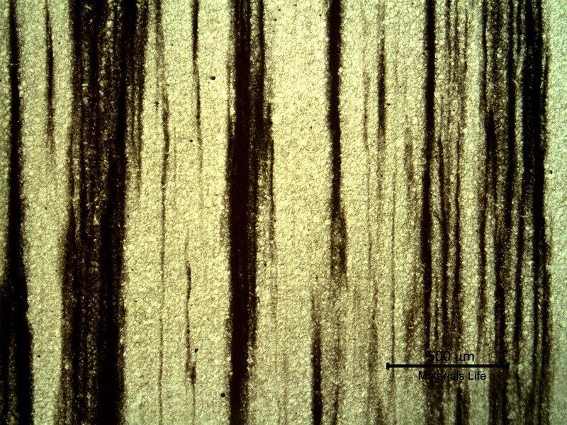Low magnification micrography, revealing (in black) the impurities in the segregated bands.