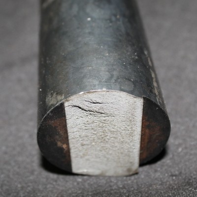 Flat fracture, no plastic deformation, at the notch in the recess.