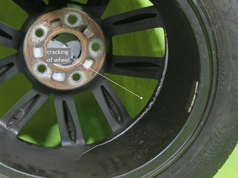 Front wheel 17 x 7J of a passenger vehicle (identified as WHEEL 2) that cracked exactly in the same location that the other front wheel broke.