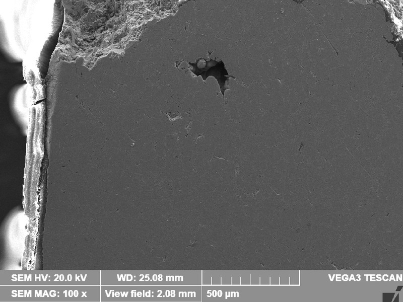 Low magnification micrography transverse to the fracture surface of the WHEEL 1.   The fracture is in the top of the image and there is a void (shrinkage) not connected to the fracture .