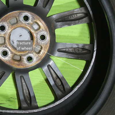 Front wheel 17 x 7J of a passenger vehicle (identified as WHEEL 1) that broke during a car accident on a road.