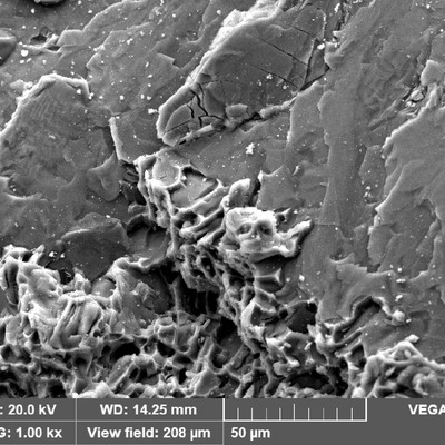 WHEEL 1 fracture detail showing small regions with smooth aspect, and brittle microcracks.  But predominantly the micromechanism is by dimples.