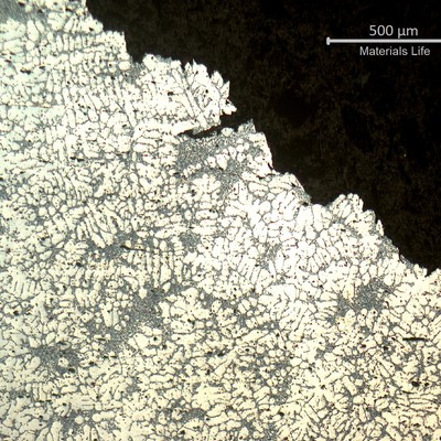 Micrography transverse to the fracture surface of the WHEEL 1. The fracture is in the up right position of the photo and it can be observed a secondary cracking following the interdendritic precipitates.