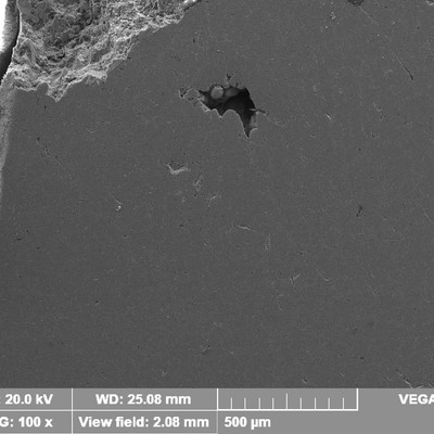 Low magnification micrography transverse to the fracture surface of the WHEEL 1.   The fracture is in the top of the image and there is a void (shrinkage) not connected to the fracture .