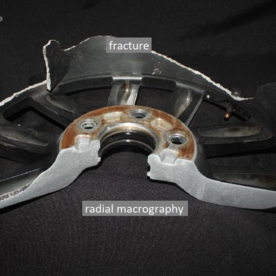 Macrography of a radial section of the WHEEL 1.  The fracture occurred in the cylindrical wheel outer edge, the rim, and the thickness of the part in the fracture location varied from 2.5 mm to 4 mm.